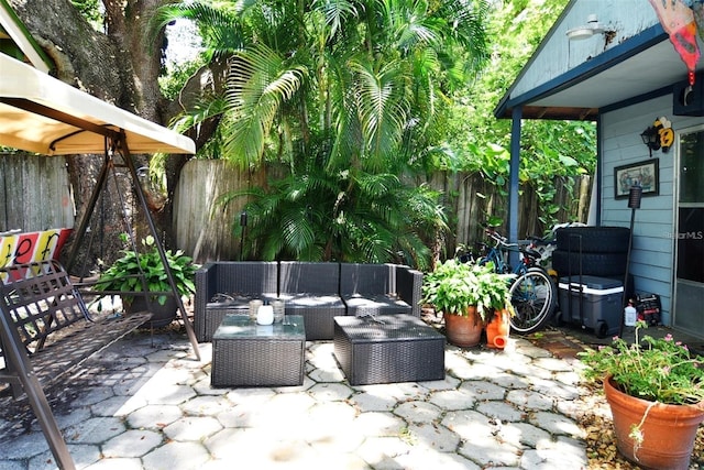 view of patio / terrace featuring an outdoor living space and a fenced backyard