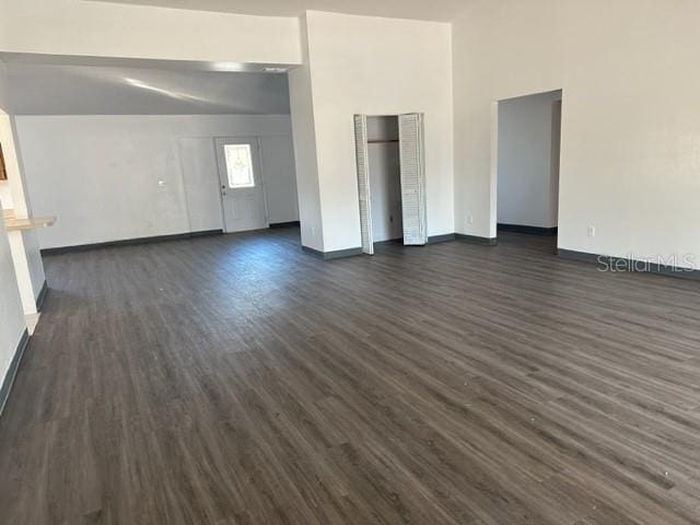 unfurnished bedroom featuring baseboards and dark wood finished floors