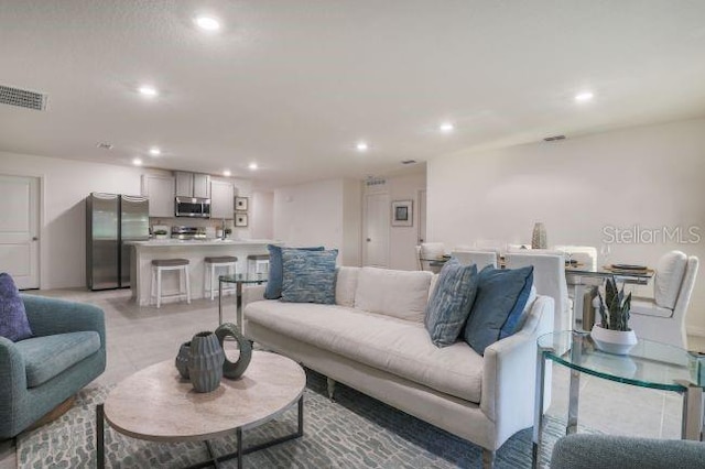 living area with recessed lighting and visible vents