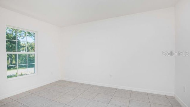 unfurnished room featuring baseboards