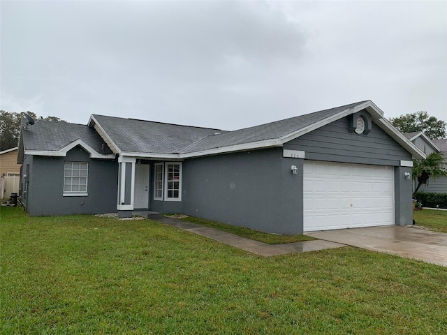 single story home featuring a garage, concrete driveway, a front yard, and stucco siding