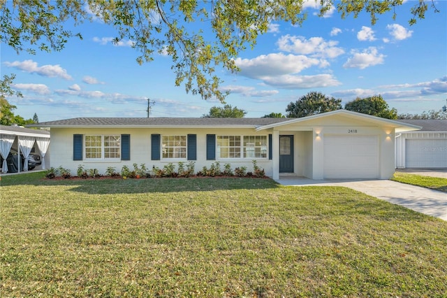 single story home featuring a front yard, a garage, and driveway