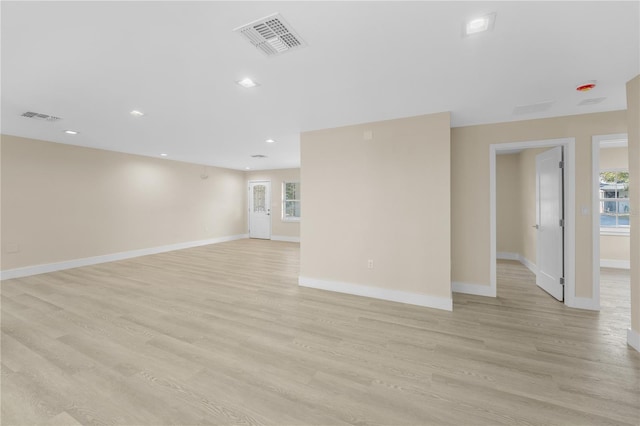 spare room with baseboards, visible vents, and light wood-type flooring