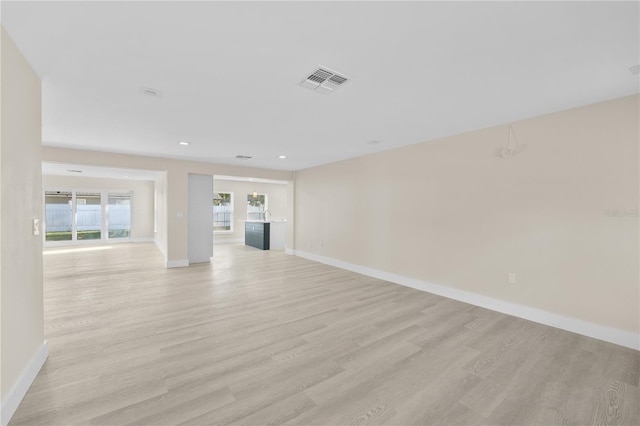 unfurnished living room with recessed lighting, baseboards, visible vents, and light wood-type flooring