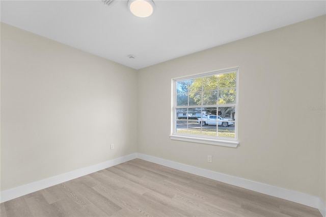 empty room featuring light wood-style floors and baseboards