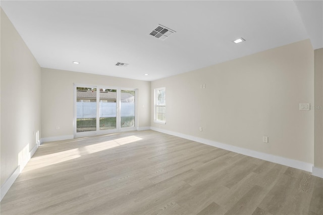 unfurnished room with visible vents, baseboards, and light wood finished floors