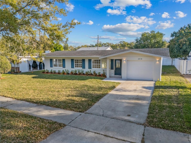 ranch-style house with fence, driveway, stucco siding, a front lawn, and a garage