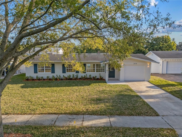 ranch-style house with stucco siding, an attached garage, concrete driveway, and a front lawn