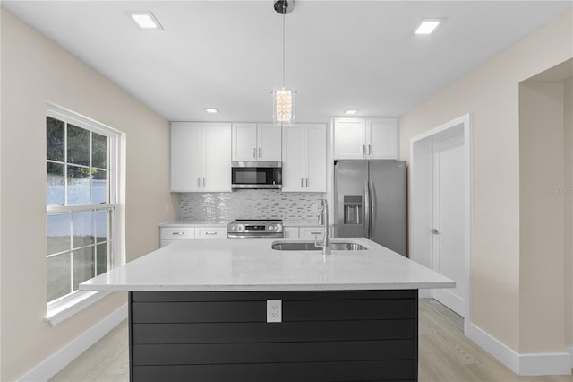 2418 Whitehall Cir, Winter Park, FL 32792 - kitchen featuring white cabinetry, decorative backsplash, a sink, and stainless steel appliances