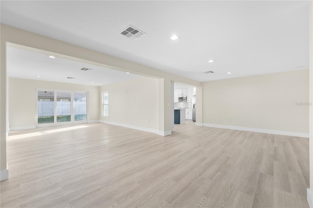 2418 Whitehall Cir, Winter Park, FL 32792 - unfurnished living room featuring visible vents, baseboards, light wood finished floors, and recessed lighting