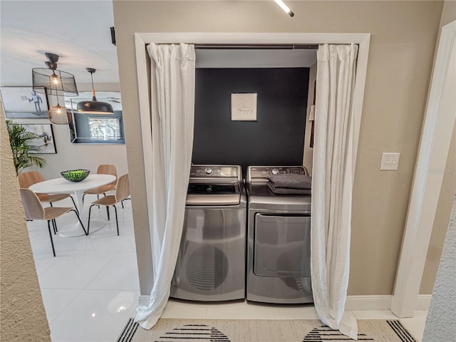 1174 Villa Ln Unit 115, Apopka, FL 32712 - laundry room with washing machine and clothes dryer and light tile patterned floors
