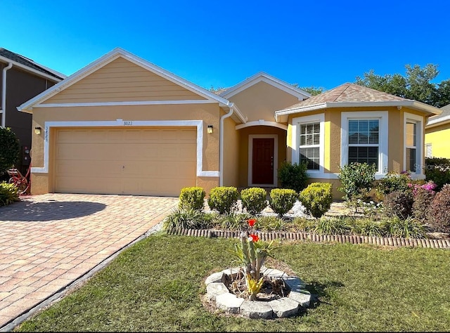 3823 Ryegrass St, Clermont, FL 34714 - single story home featuring decorative driveway, an attached garage, and stucco siding