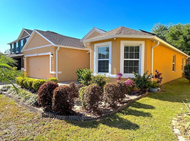 3823 Ryegrass St, Clermont, FL 34714 - view of front of home with an attached garage, a front lawn, roof with shingles, and stucco siding