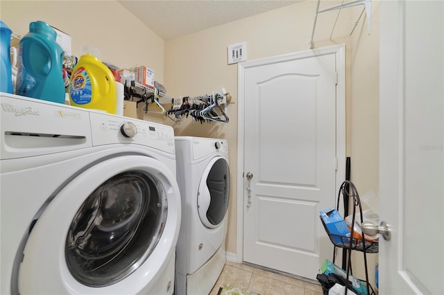 3823 Ryegrass St, Clermont, FL 34714 - laundry area with laundry area, a textured ceiling, light tile patterned flooring, and separate washer and dryer
