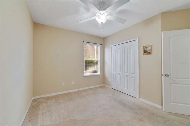 3823 Ryegrass St, Clermont, FL 34714 - unfurnished bedroom featuring baseboards, light carpet, ceiling fan, and a closet