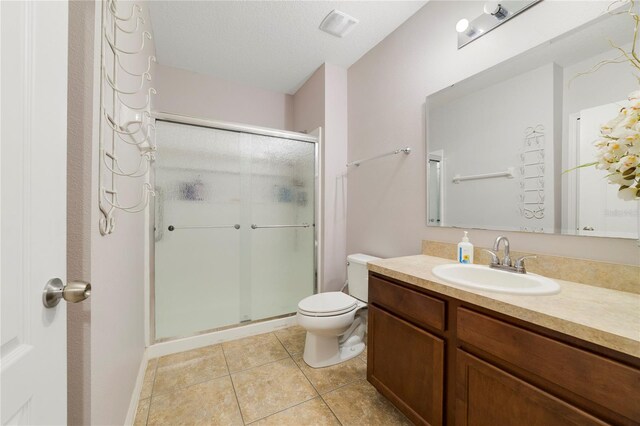3823 Ryegrass St, Clermont, FL 34714 - bathroom with tile patterned flooring, vanity, toilet, a shower stall, and visible vents
