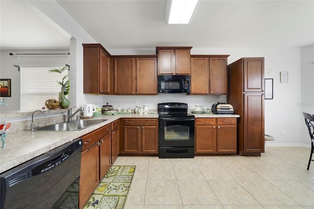 3823 Ryegrass St, Clermont, FL 34714 - kitchen with light countertops, a textured ceiling, a sink, light tile patterned floors, and black appliances