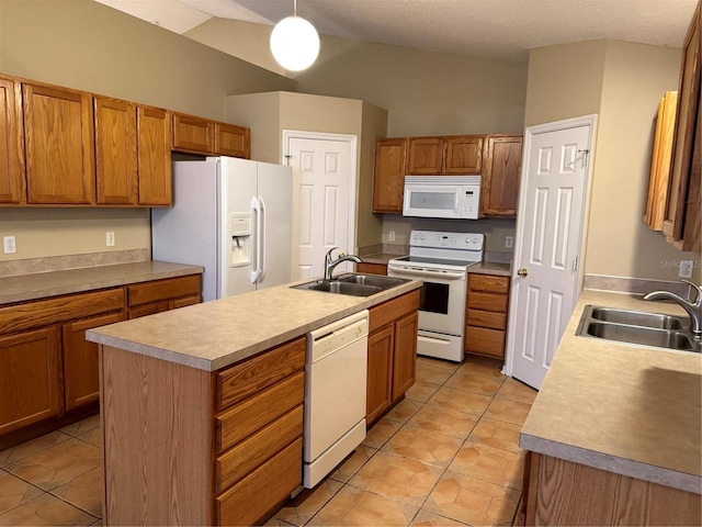 kitchen with white appliances, light tile patterned flooring, light countertops, and a sink