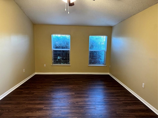 unfurnished room featuring a textured ceiling, wood finished floors, a healthy amount of sunlight, and ceiling fan