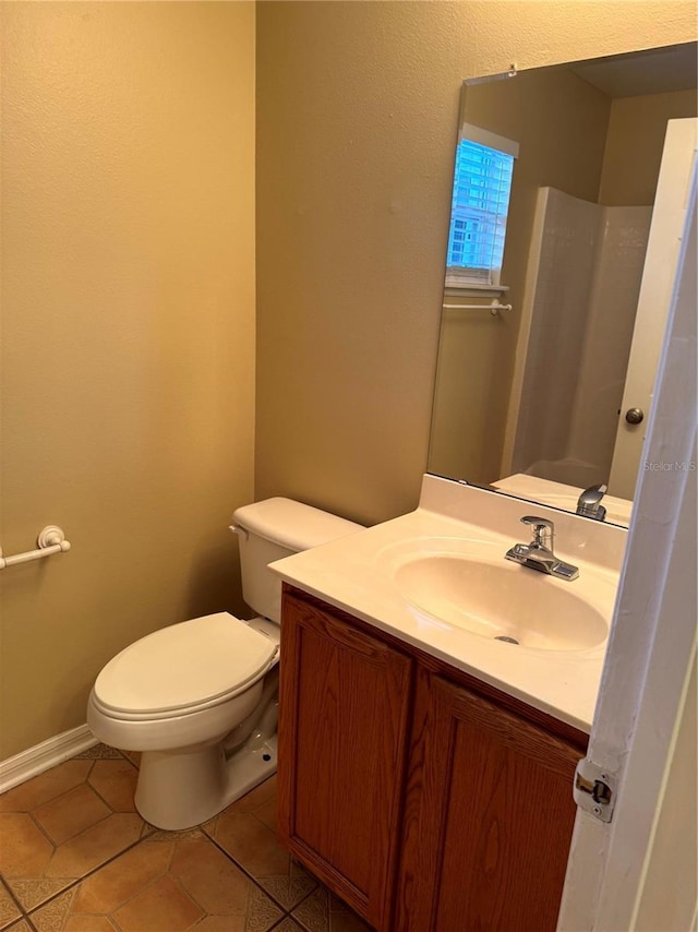 bathroom featuring tile patterned flooring, toilet, vanity, and baseboards