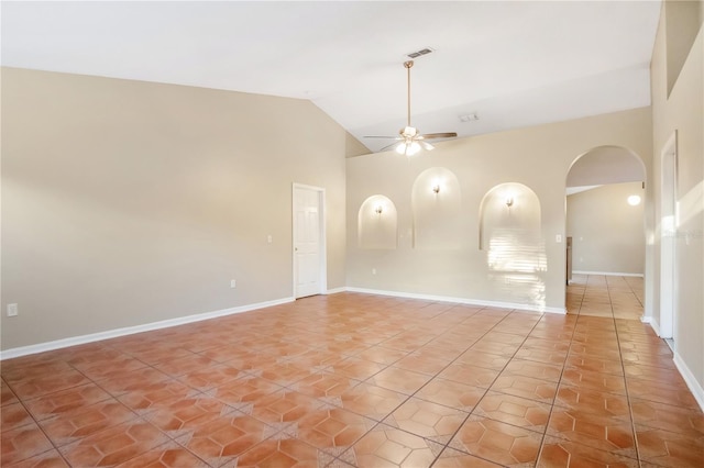 unfurnished room featuring light tile patterned floors, baseboards, visible vents, arched walkways, and ceiling fan