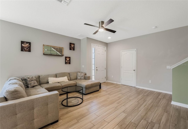 living room featuring visible vents, baseboards, recessed lighting, ceiling fan, and light wood-type flooring