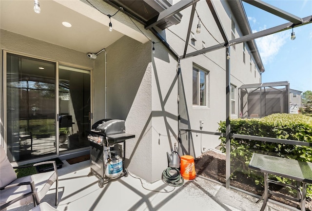 view of patio featuring a grill and a lanai