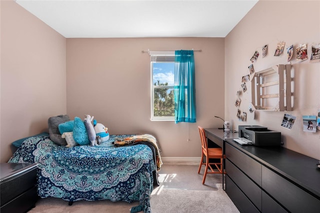 bedroom with light carpet and baseboards