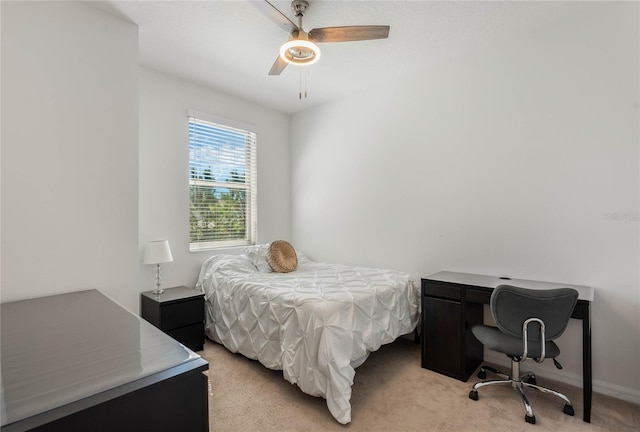 bedroom with ceiling fan, baseboards, and light carpet