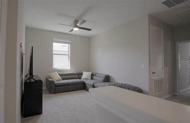 living room featuring visible vents, light colored carpet, and ceiling fan