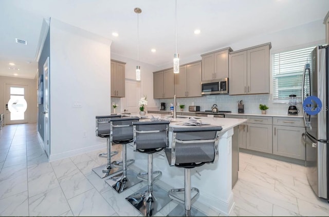 kitchen with marble finish floor, gray cabinetry, and stainless steel appliances