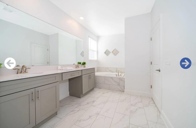 full bath featuring visible vents, a garden tub, double vanity, marble finish floor, and a sink