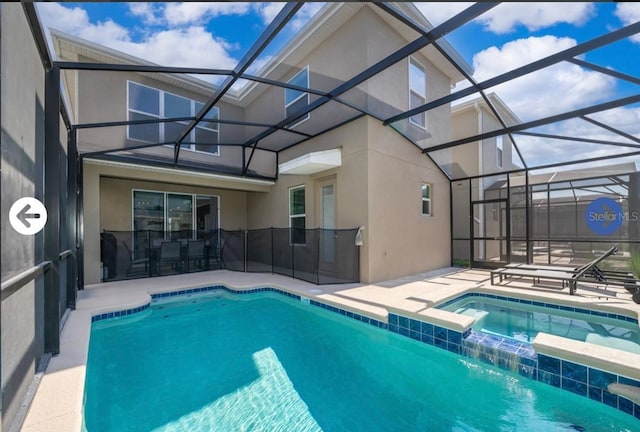 view of swimming pool with a patio area, a pool with connected hot tub, and a lanai