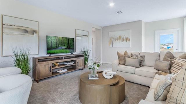 living area featuring visible vents and carpet floors