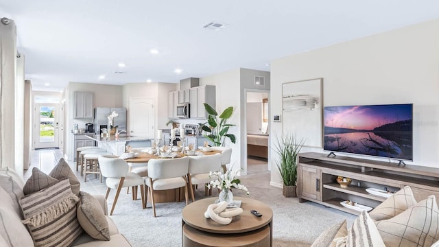 living area with visible vents and recessed lighting