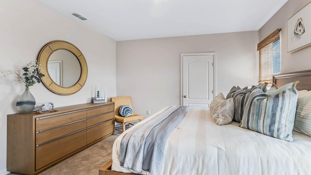 bedroom with visible vents and carpet floors