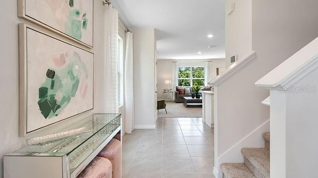 hall with stairs, light tile patterned floors, and recessed lighting