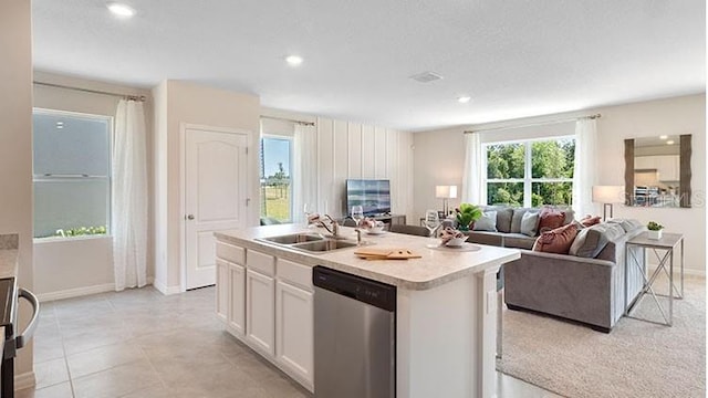 kitchen featuring a sink, dishwasher, open floor plan, and light countertops