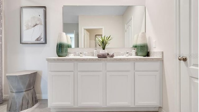 bathroom featuring double vanity and a sink