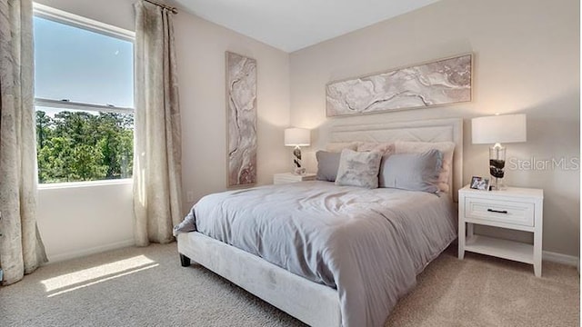 carpeted bedroom with baseboards