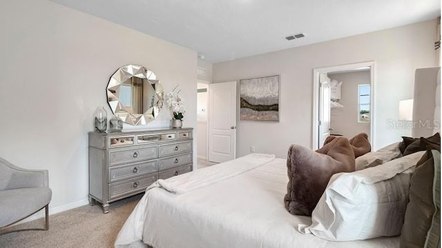 bedroom with visible vents, baseboards, and light colored carpet