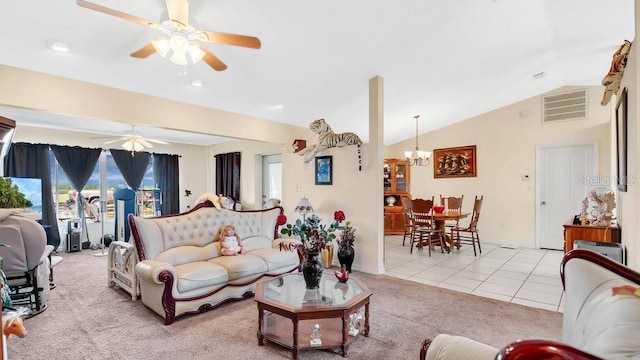 living area with light tile patterned floors, visible vents, light carpet, and ceiling fan with notable chandelier