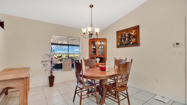 dining room featuring lofted ceiling, a notable chandelier, light tile patterned flooring, and baseboards