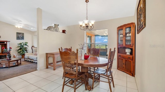 dining room with light tile patterned flooring, ceiling fan with notable chandelier, light carpet, and lofted ceiling