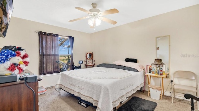 carpeted bedroom with baseboards and ceiling fan