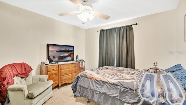 bedroom featuring ceiling fan and light carpet