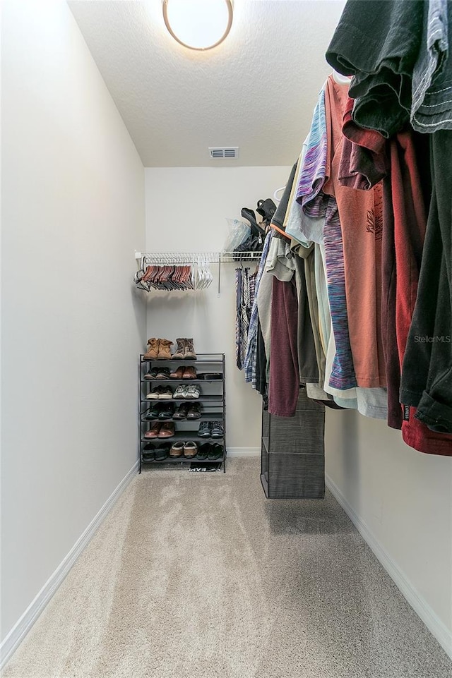 spacious closet with carpet and visible vents