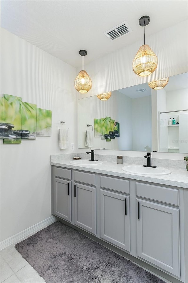 bathroom featuring double vanity, visible vents, and a sink