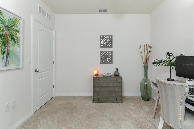 carpeted office featuring visible vents and baseboards