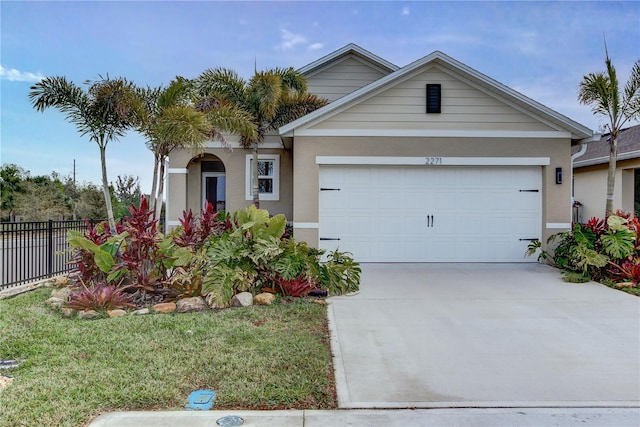 ranch-style house with stucco siding, a garage, concrete driveway, and fence